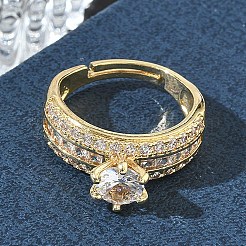 ラウンドキュービックジルコニアを中央に、バゲットカットのアクセントをあしらった、女性向けの調節可能な真鍮製指輪  長持ちメッキ  ゴールドカラー  ラウンド：8x6mm  内径：17mm&nbsp;CU-CBA7E55-16G